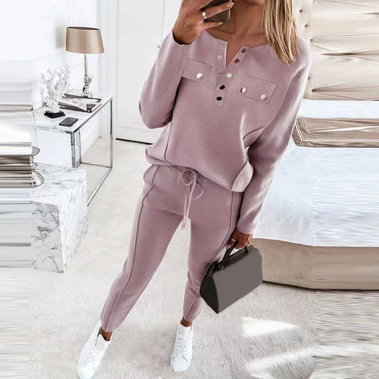 Cozy two-piece loungewear set with crew-neck sweater top and drawstring pants in pink, grey, and navy blue colors