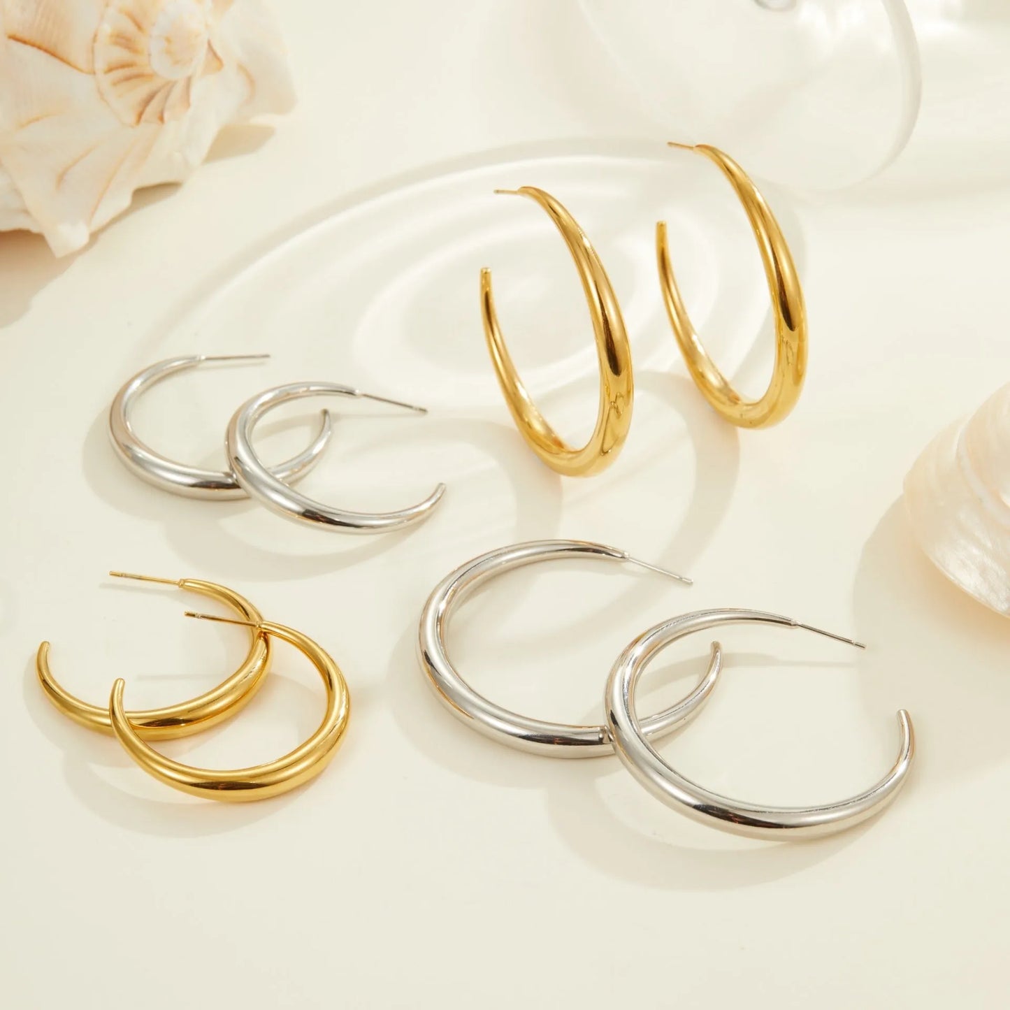 Women's stainless steel hoop earrings in two sizes with gold or steel finish