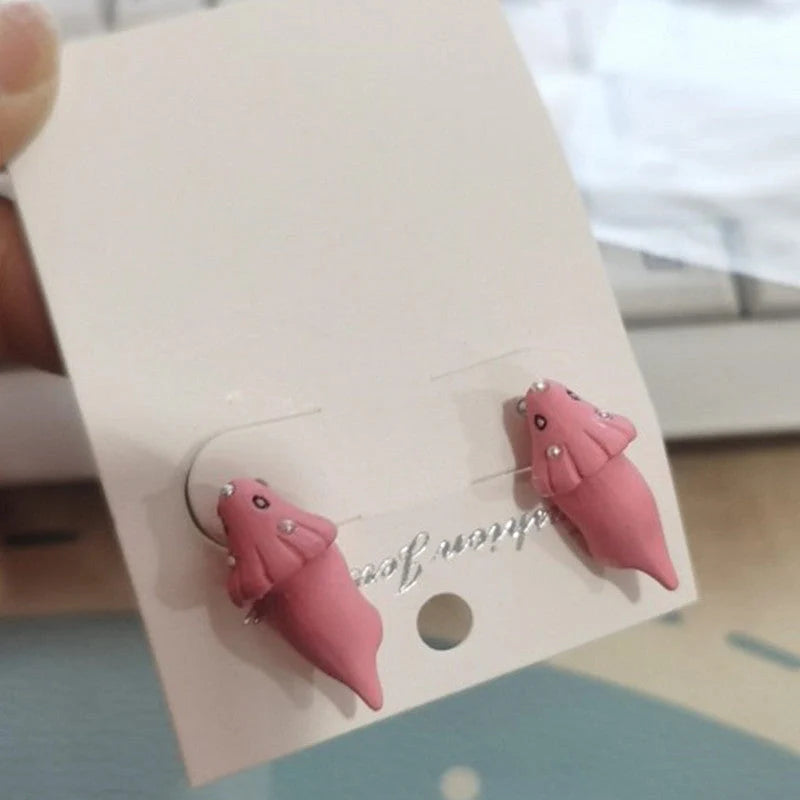 Funny animal bite earrings featuring dinosaur and whale designs in various colors