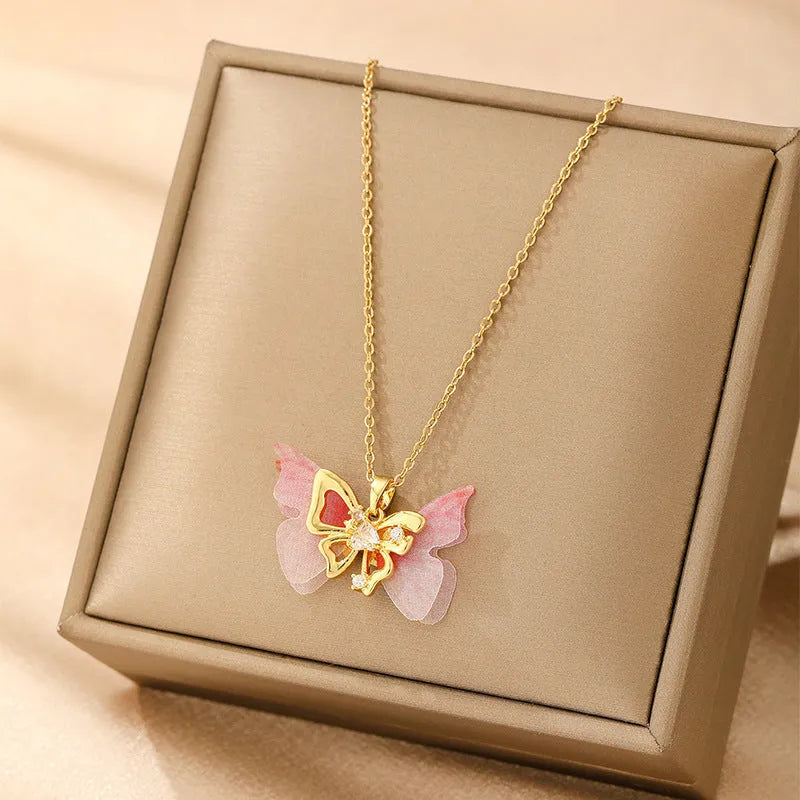 Women's gold electroplated copper necklace showing four pendant options: heart, butterfly, cross and round diamond