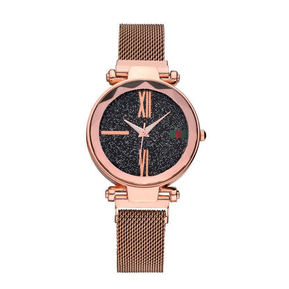 Rose gold ladies watch with round 32mm dial and magnetic stainless steel jewellery clasp on wrist.