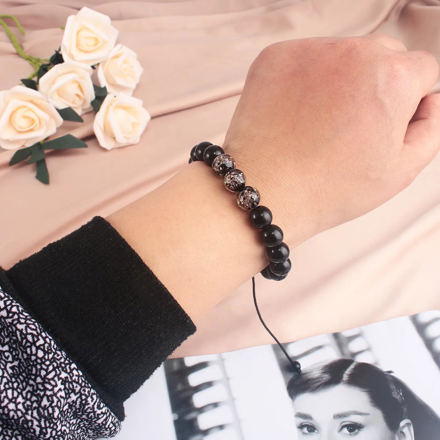 Adjustable bracelet with luminous geometric glass beads in six colour options on a wrist