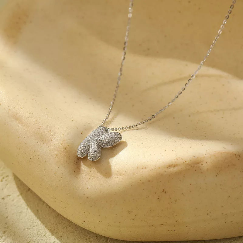 Stainless steel initial pendant necklace with zircon accents, personalized with your choice of letter.