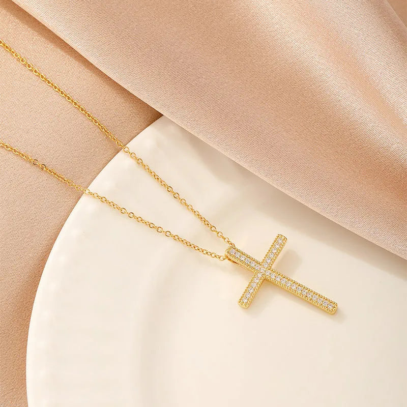 Women's gold electroplated copper necklace showing four pendant options: heart, butterfly, cross and round diamond