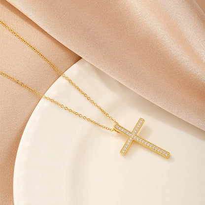 Women's gold electroplated copper necklace showing four pendant options: heart, butterfly, cross and round diamond