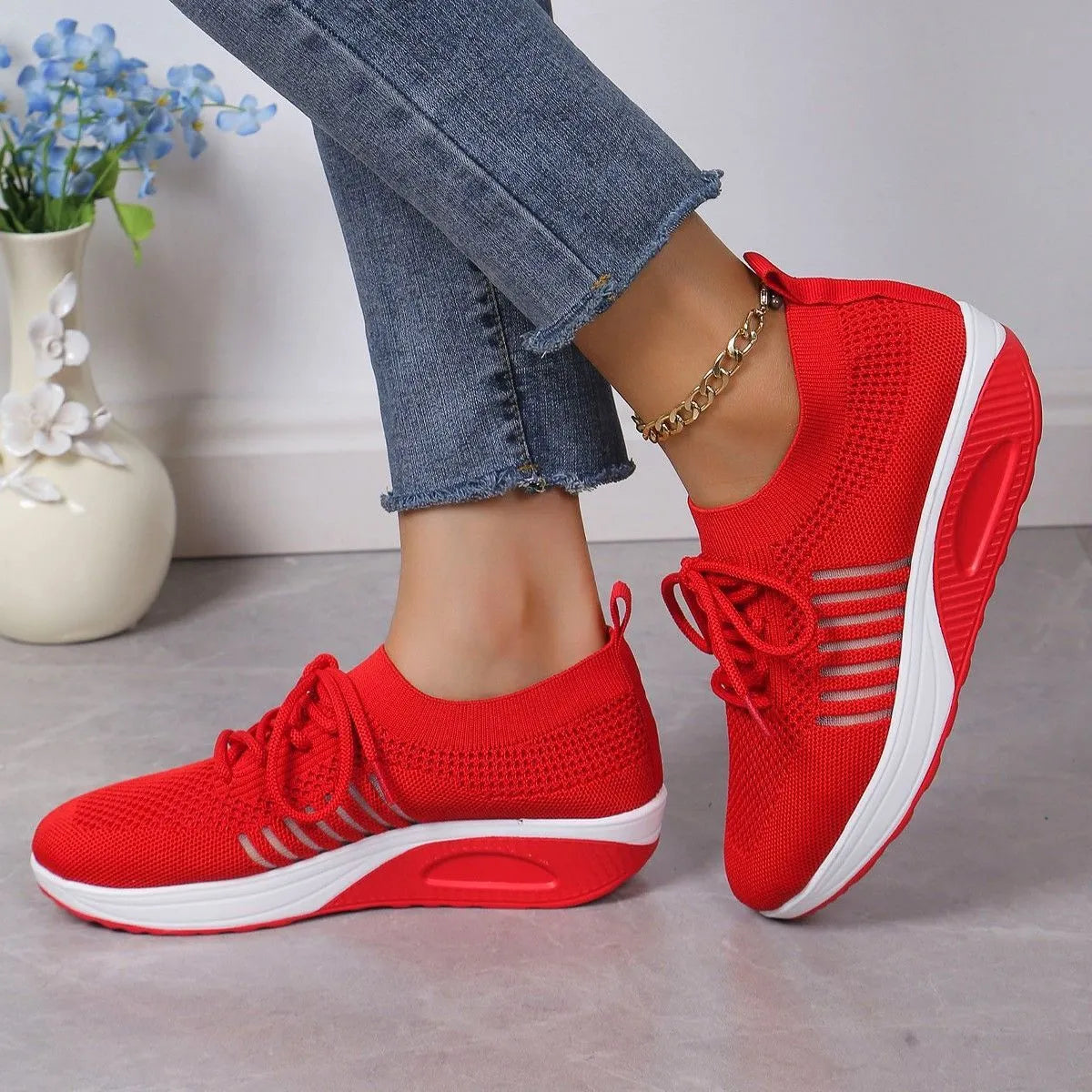 Women's red platform sneakers with mesh upper and front lace-up design on rubber sole