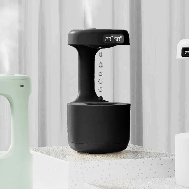 White columnar anti-gravity humidifier with LED clock display on a wooden desk
