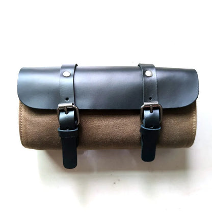 Camel Bag Knight retro cotton messenger bag in army green, showing front flap, rivet details, and size next to a motorcycle helmet.
