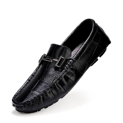 Men's brown leather casual shoes with silver buckle fastening, showing textured rubber sole and low-cut design
