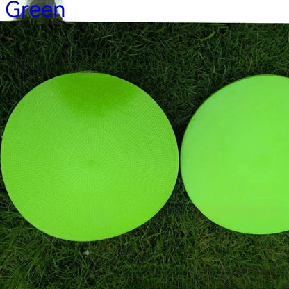 Soft yellow TPE football landmark pad disc on grass, 23 cm diameter.