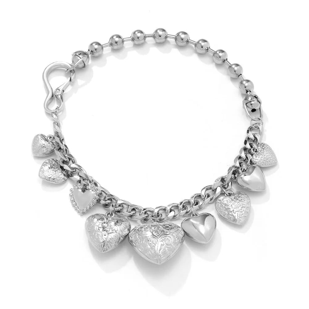 Gold carved heart pendant necklace on adjustable chain, showing exaggerated shape and textured details