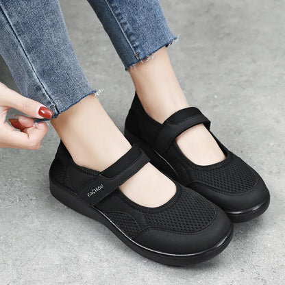 Women's grey velcro casual shoes with mesh upper and flat sole.
