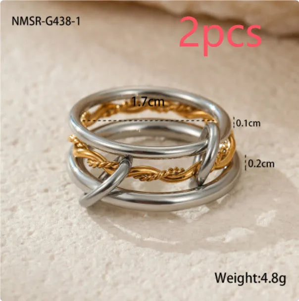 Stacked stainless steel rings with 18K gold plating in three colour variations, exaggerated hand jewellery designs