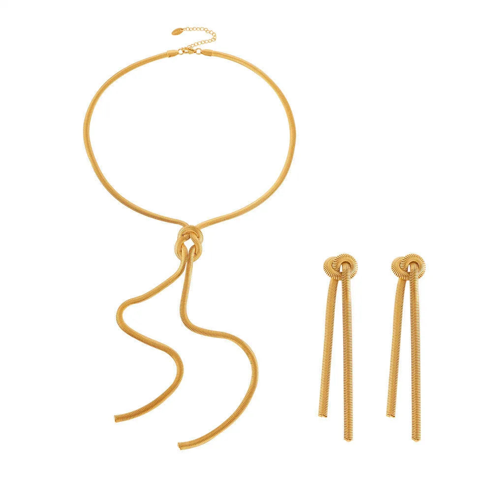 Gold electroplated titanium steel knotted tassel necklace and matching earrings set on a white background.