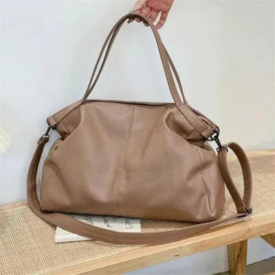 Large soft black PU messenger bag with long shoulder strap and front car suture detailing
