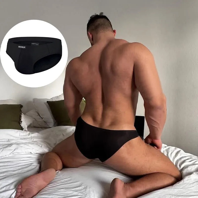 Men's solid colour seamless briefs in low waist style shown in black, white, and pink.
