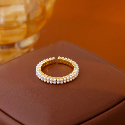 Gold electroplated pearl ring with open mouth geometric design and round pearl elements