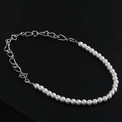White geometric acrylic asymmetric clavicle chain necklace on a twisted chain.