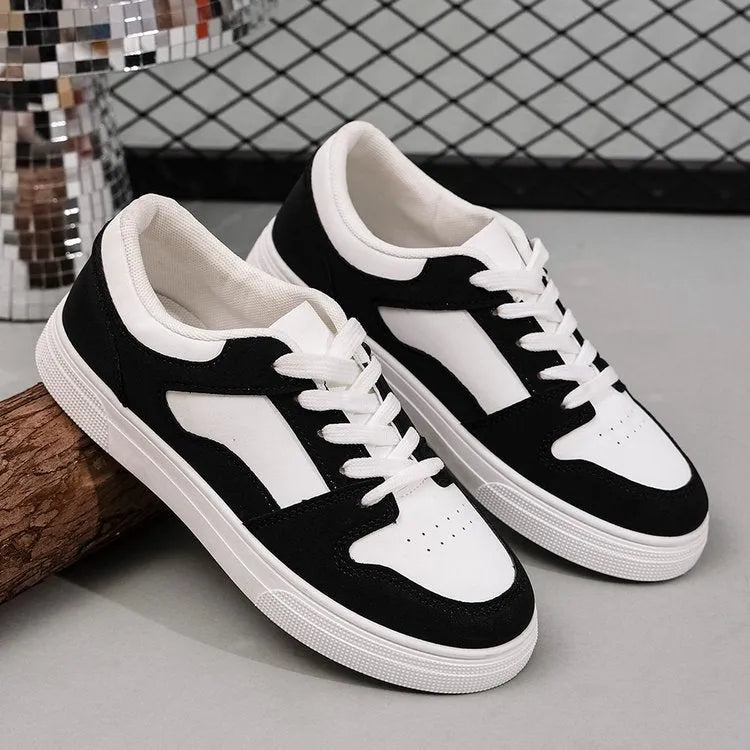 Black women's low-top lace-up casual sports shoes with a round toe and flat rubber sole.