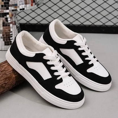 Black women's low-top lace-up casual sports shoes with a round toe and flat rubber sole.