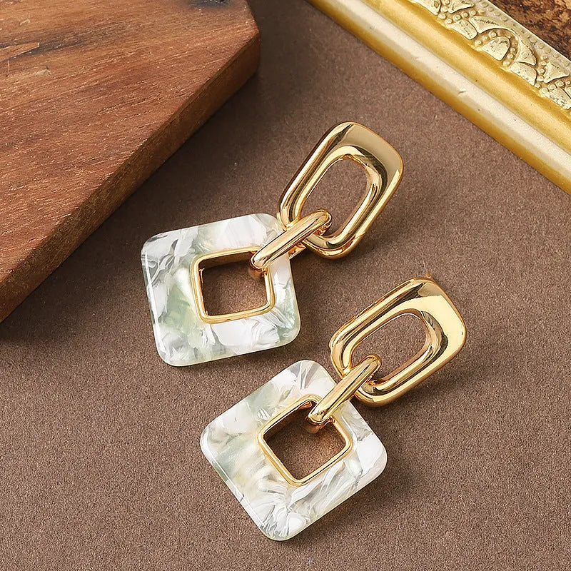 Hollow geometric square earrings with chamfered corners and electroplated copper finish