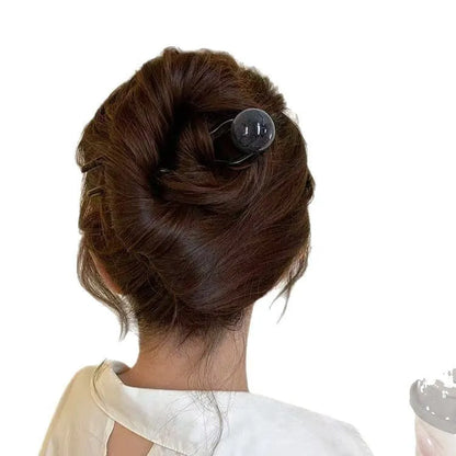 Acrylic U-shaped hair barrette with retro ball design in caramel colour
