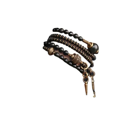 Black geometric layered beaded bracelet shown on a wrist.