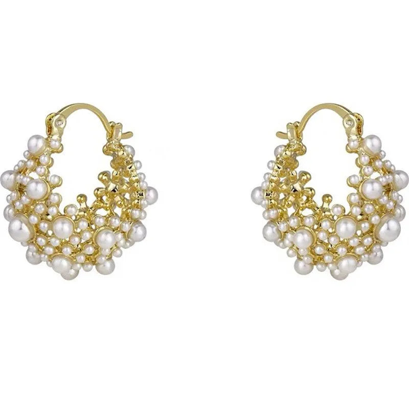 Gold-colour copper flower basket earrings with small rice-shaped bead inlay detail.