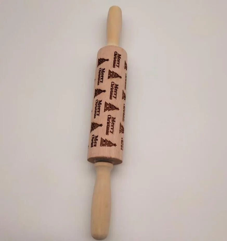 Wooden rolling pin with engraved Christmas patterns including reindeer and snowflakes on a 45cm long barrel.