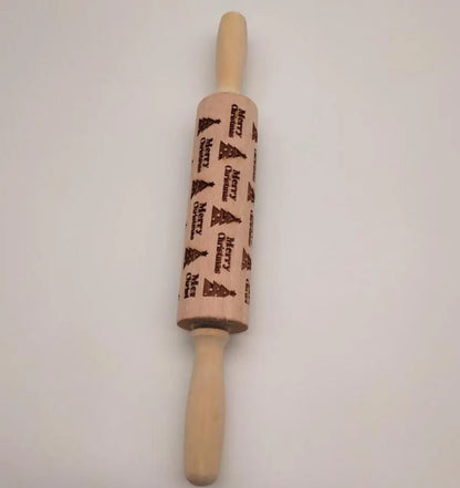 Wooden rolling pin with engraved Christmas patterns including reindeer and snowflakes on a 45cm long barrel.