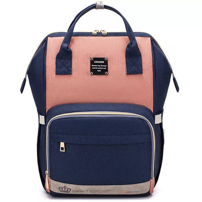 Mummy Maternity Bag in various colors, featuring a backpack design and zipper closure