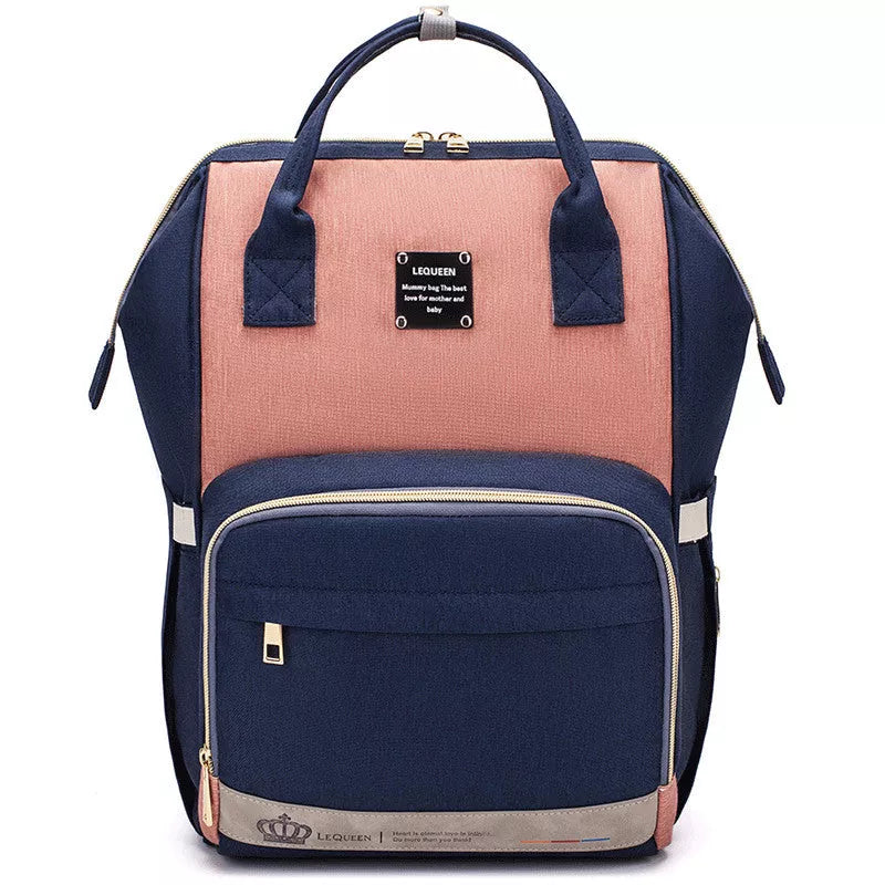 Mummy Maternity Bag in various colors, featuring a backpack design and zipper closure