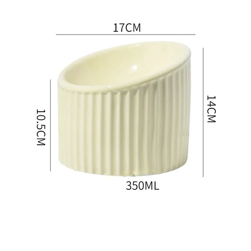 Ceramic raised cat bowl in light green, showing elevated tilted design for pet feeding.