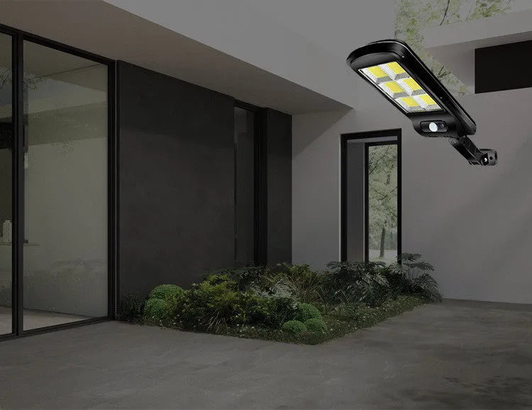 Black solar motion sensor security light for outdoor garden or fence installation with IP65 waterproof rating