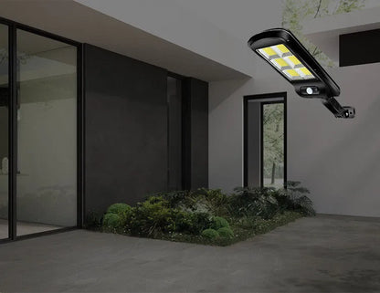 Black solar motion sensor security light for outdoor garden or fence installation with IP65 waterproof rating