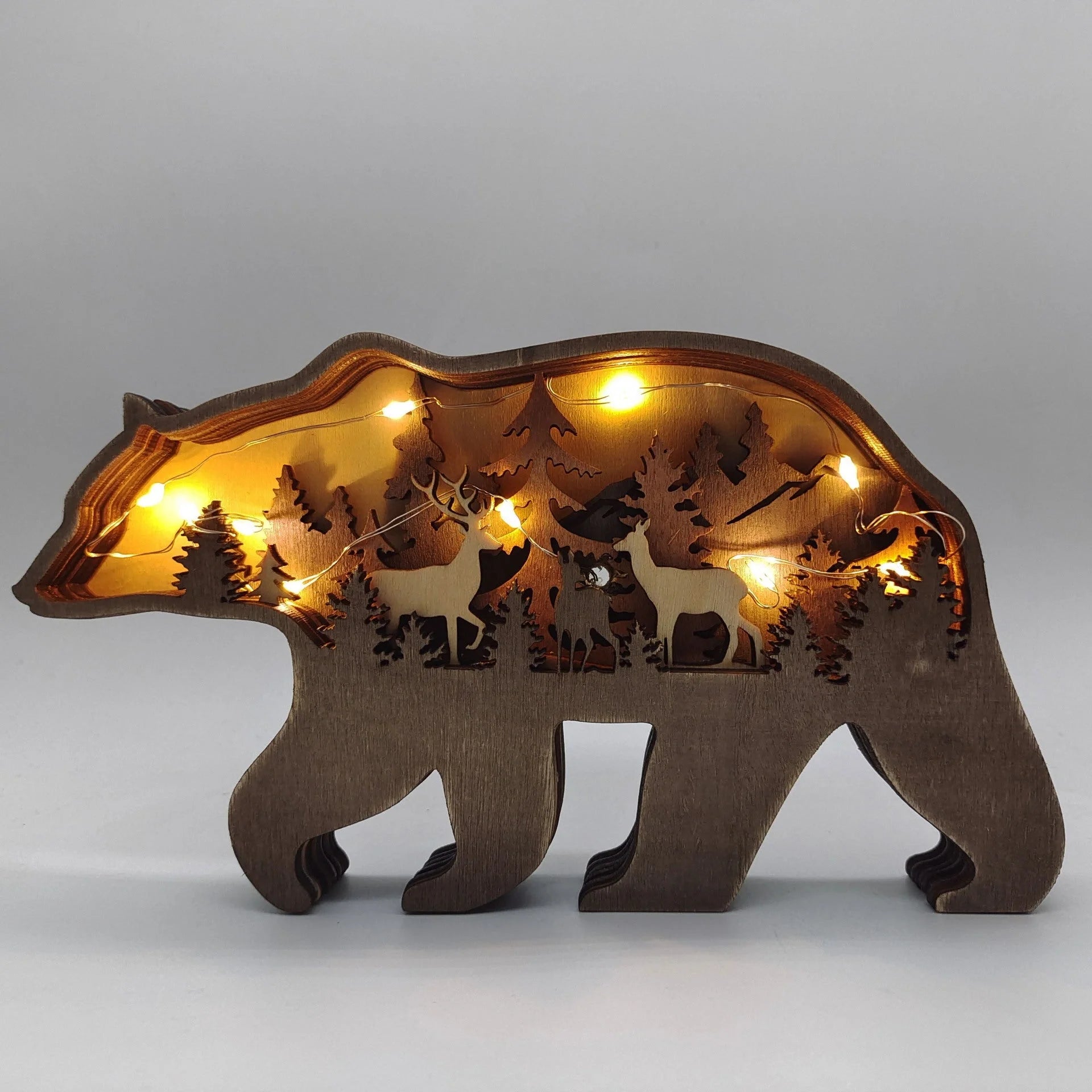 Handcrafted wooden elk and brown bear Christmas decorations with forest theme