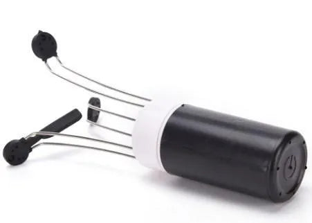White and black wireless automatic kitchen stirrer with three-speed button, shown next to a saucepan.