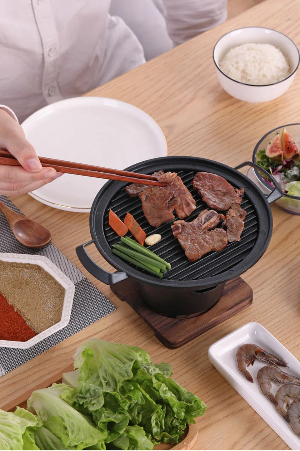 Compact tabletop barbecue grill with dual alcohol burners, made of durable aluminum with a nonstick cooking surface