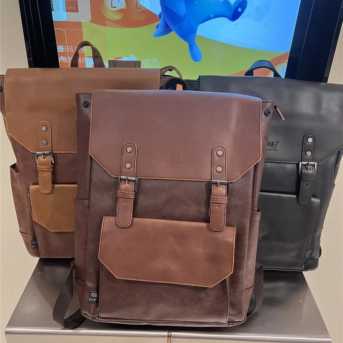 Unisex large capacity PU backpack in a solid colour, shown in college style.
