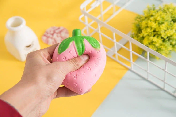 A squishy, strawberry-shaped stress relief ball made of durable polyurethane material