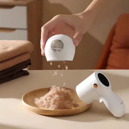 White electric lint remover with LED display showing fabric shaver dimensions 126x73x68mm