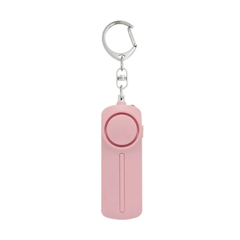 Compact pink self-defense alarm showing 86mm length with activation button and LED light