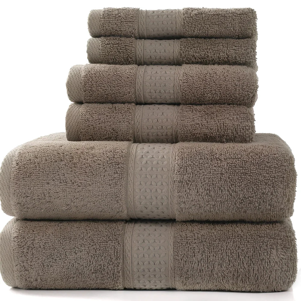 Cotton towel set showing bath towel, hand towel, and face cloth in coordinated sizes