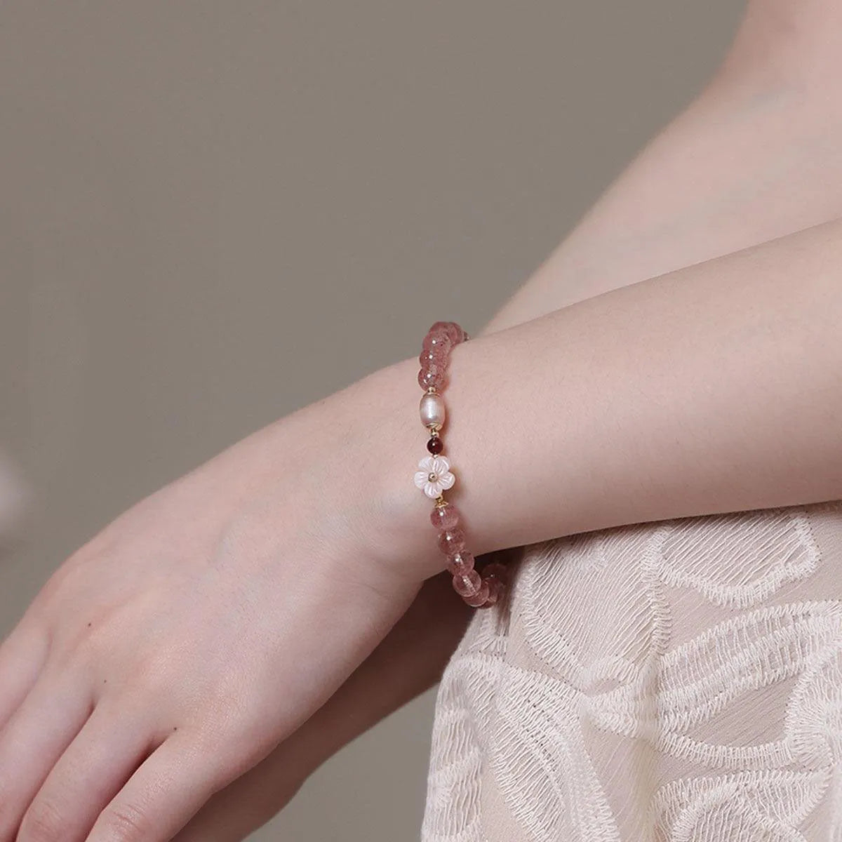 Strawberry quartz peach blossom crystal bracelet for women showing floral design.
