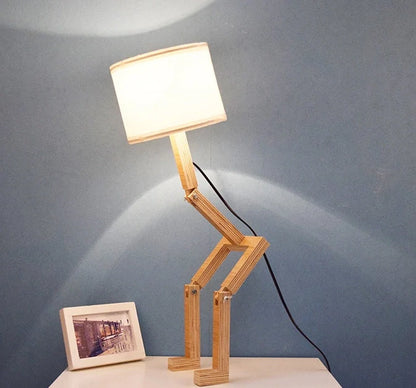 Humanoid wooden table lamp with deformable design and fabric shade for modern home decor