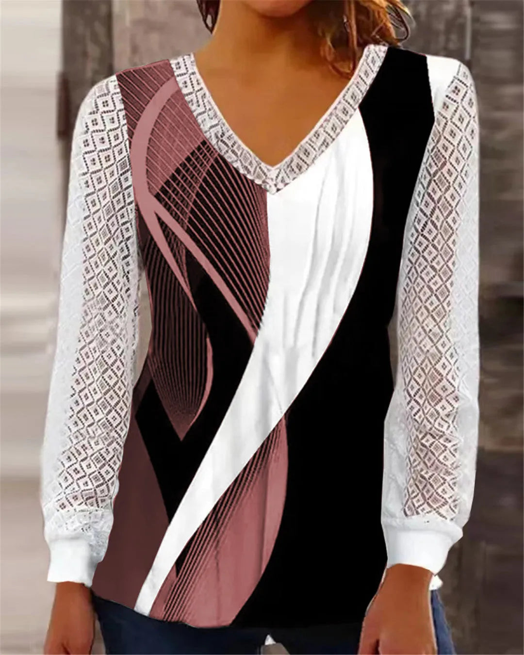 Purple V-neck loose top with hollow-out lace print and long sleeves.