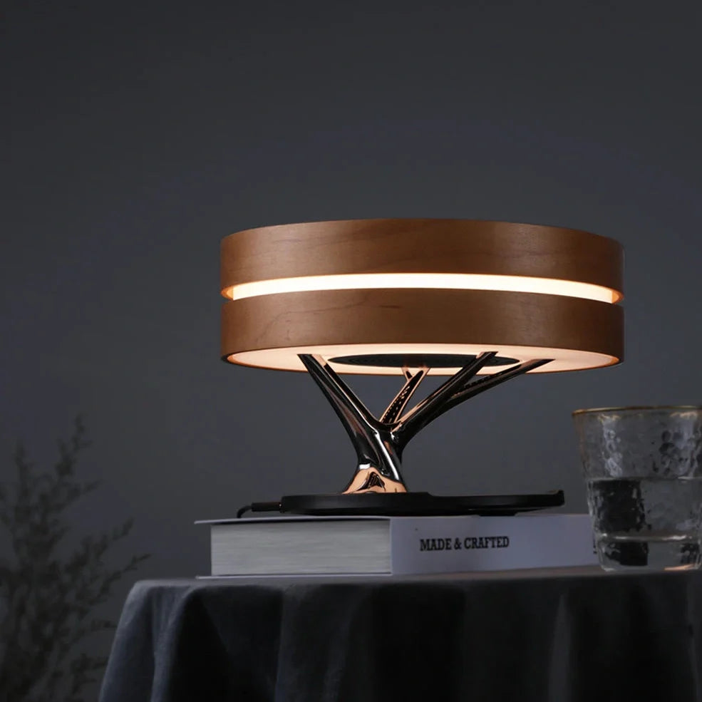 Round Bluetooth speaker with LED tree lighting and wireless charging surface in maple brown finish