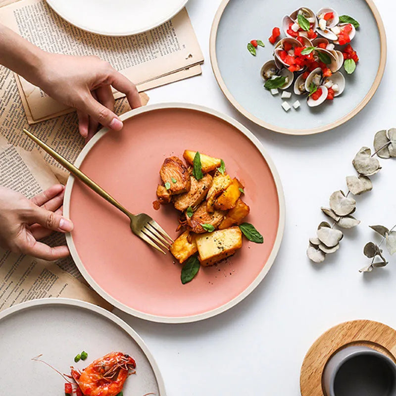 A blue matte-finish 10-inch ceramic dinner plate on a plain surface.