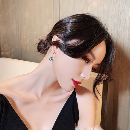 Black retro geometric circle drop earrings with hook fastening, 3.6cm long.