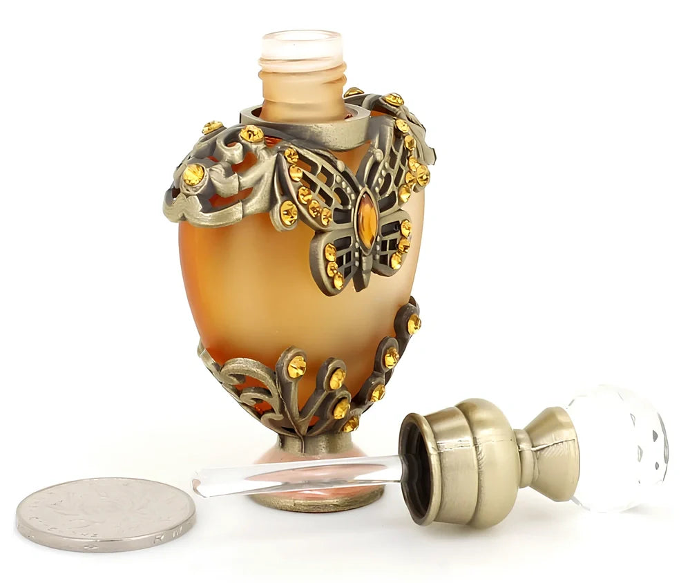 Heart-shaped refillable perfume bottle with metal and crystal construction, 3.6 inches tall